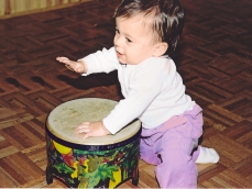 Baby playing a drum